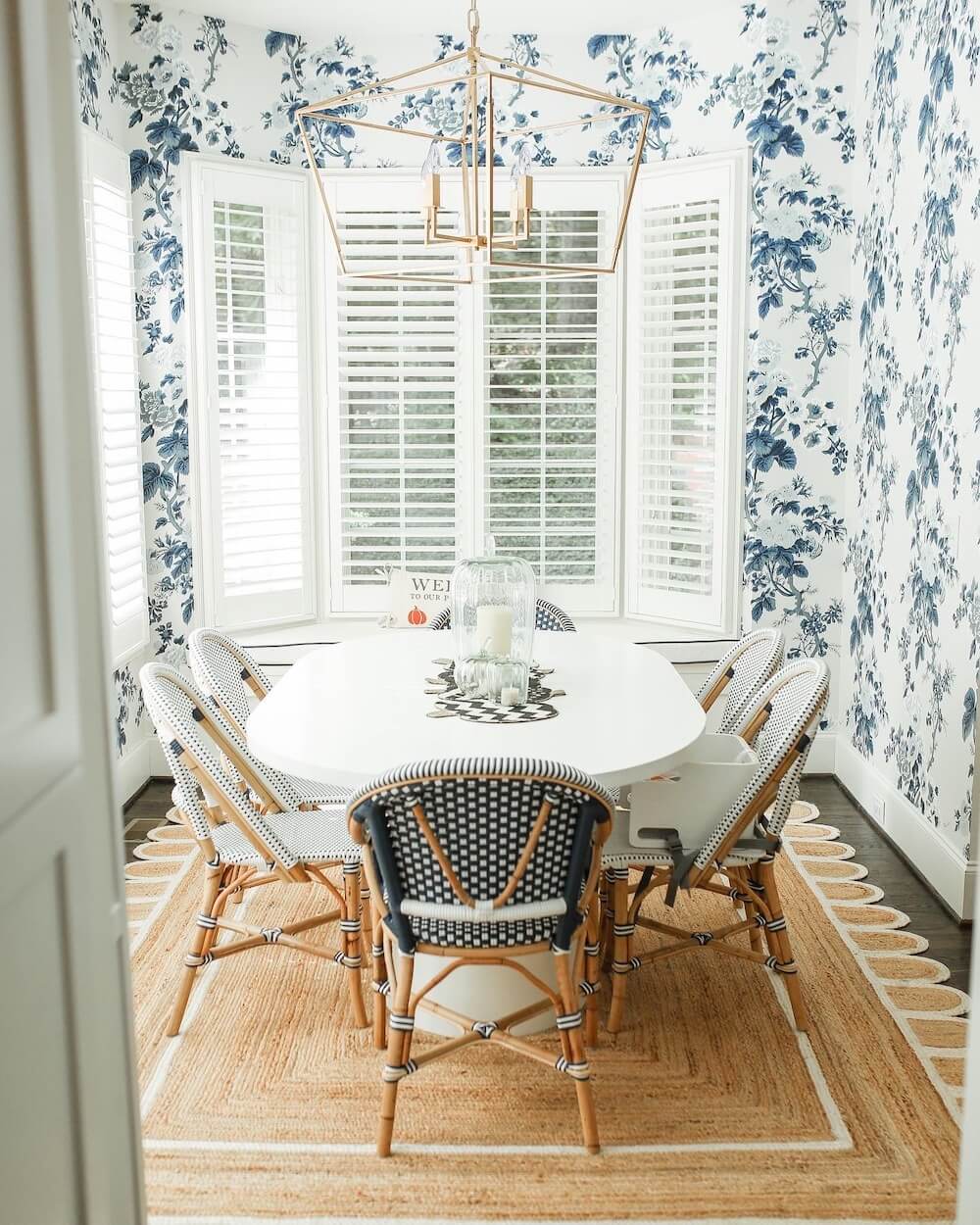 grandmillenial dining room with black and white mackenzie childs table runner